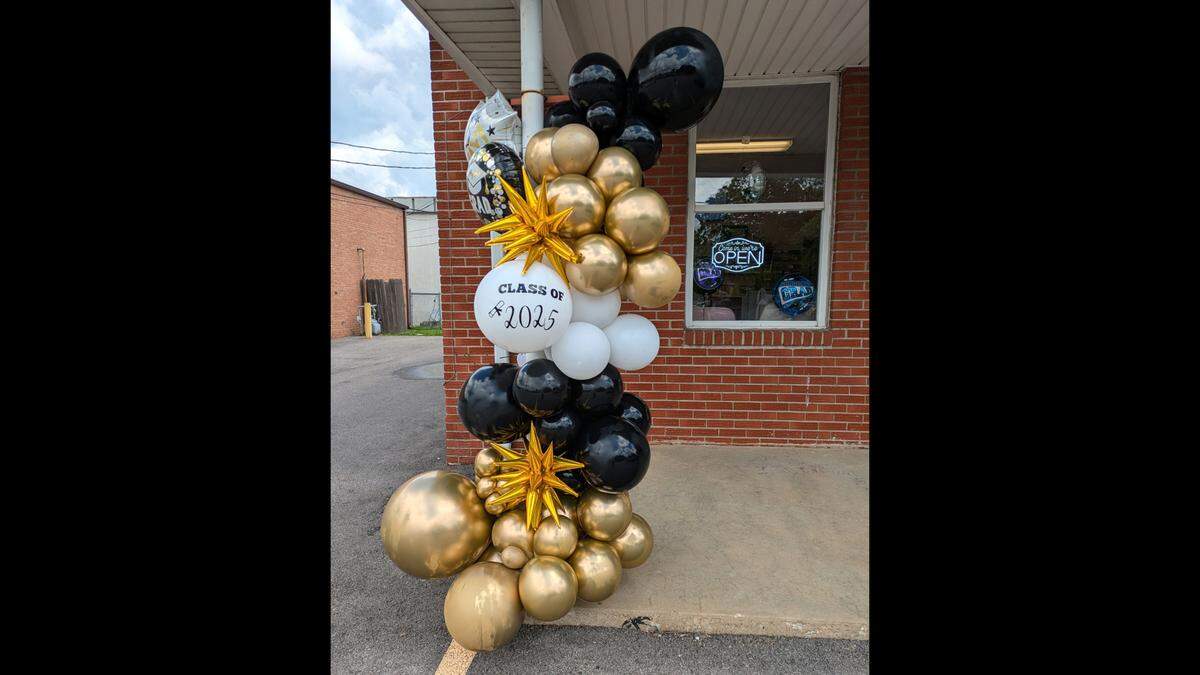 LovelyLoons makes elaborate balloon decorations like this graduation-themed display.