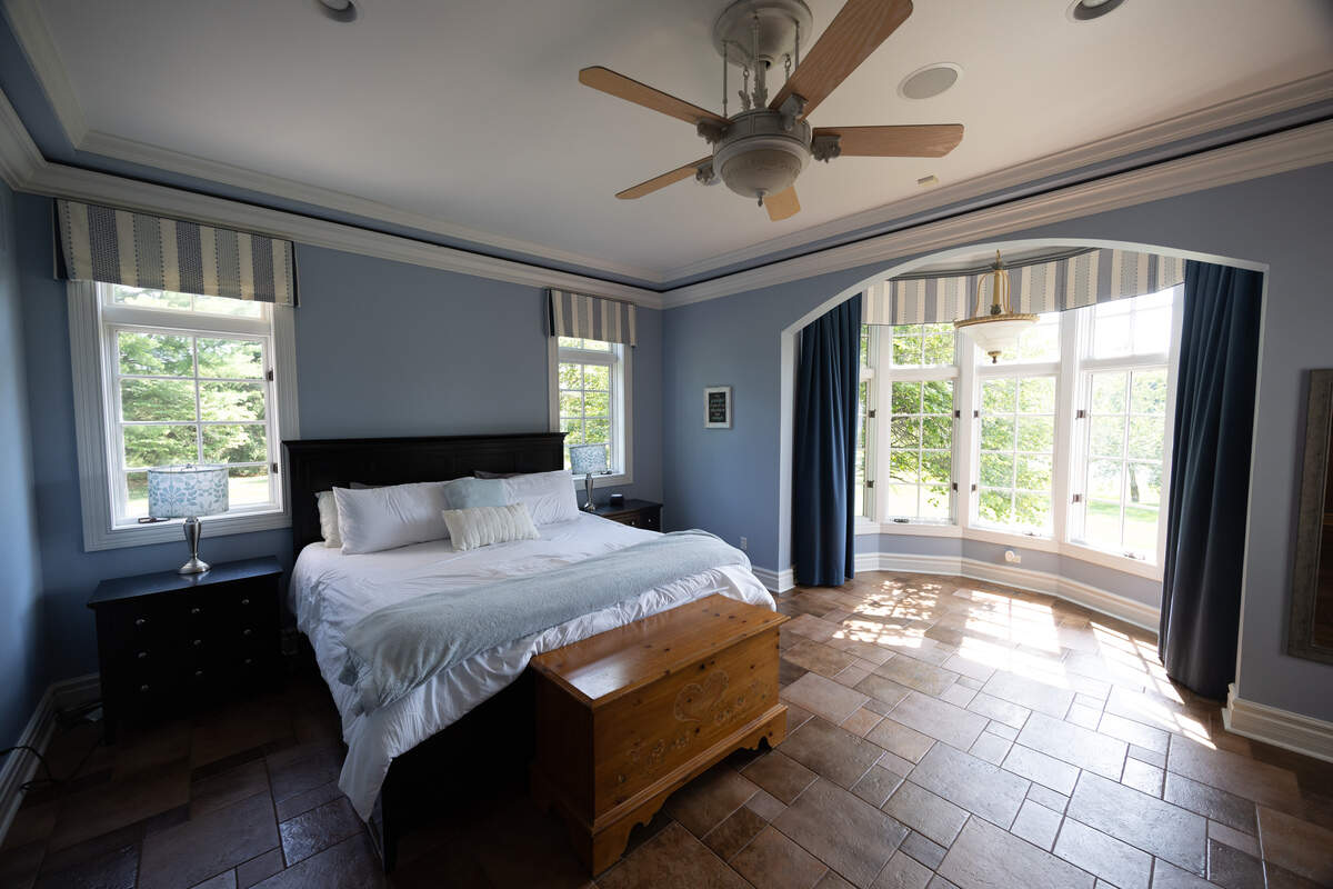 The master bedroom in the 2102 Clairmont Drive home comes with heated floors, a bay window, and a massive bathroom with a two-person shower, jacuzzi tub and Jack & Jill sinks.