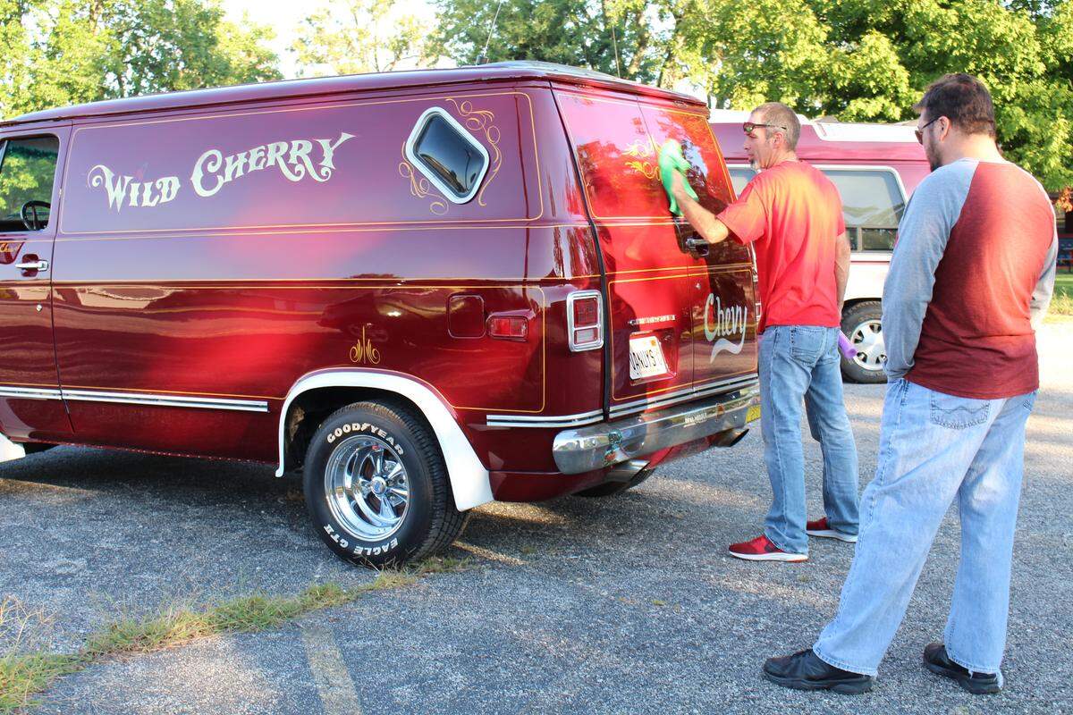 Chris Carter polishes the restored Wild Cherry van while talking to his old friend, James Langenstein, just before leaving on the Wild Cherry Van Run to California on Sept. 15, 2018.
