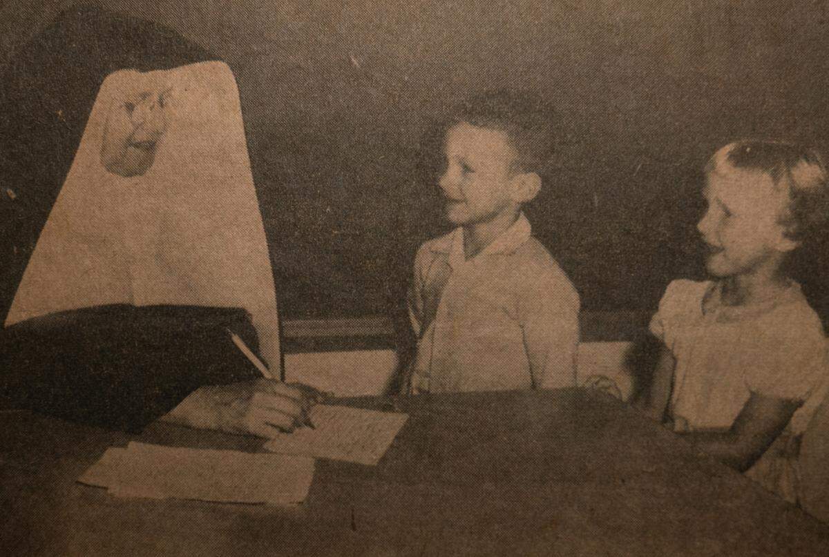 Mary Becker Schaefer and her twin brother, Mark, meet with Sister Pacifica on their first day of kindergarten in the new Cathedral Grade School building in 1958 in Belleville. This photo was originally published in the Belleville Daily Advocate.