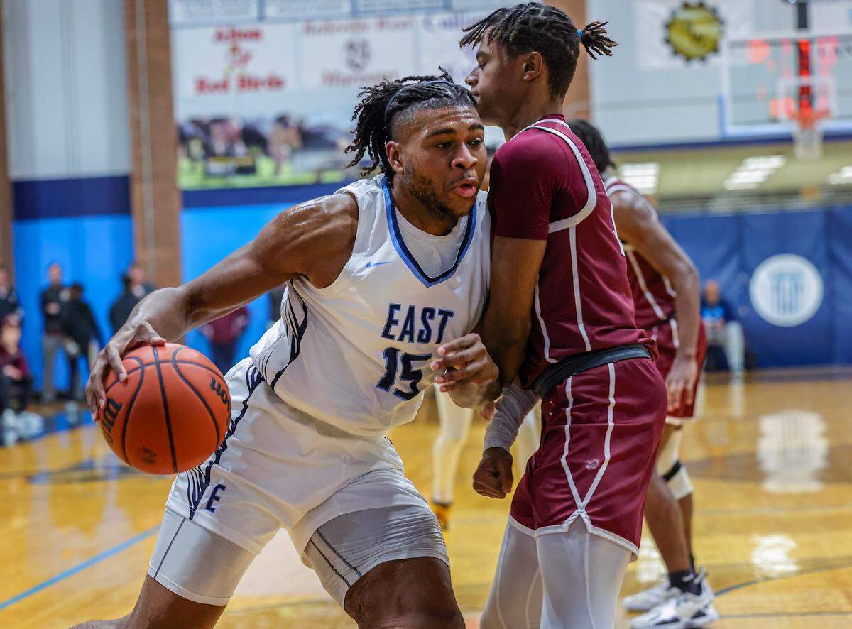 Belleville East’s Alex Jackson drives to the basket against a Belleville West defender during the Chick-fil-A Classic championship game. The Lancers ultimately posted a 57-52 victory.