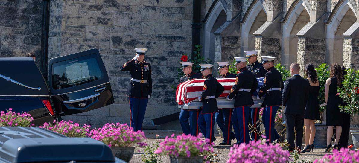 Marines carry the American flag-draped casket of Capt. Eleanor “Ellie” Cooke, formerly LeBeau, 29, from Cathedral of St. Peter Catholic Church in Belleville to a hearse after her funeral service on Sept. 23, 2023, before a 7-mile procession.