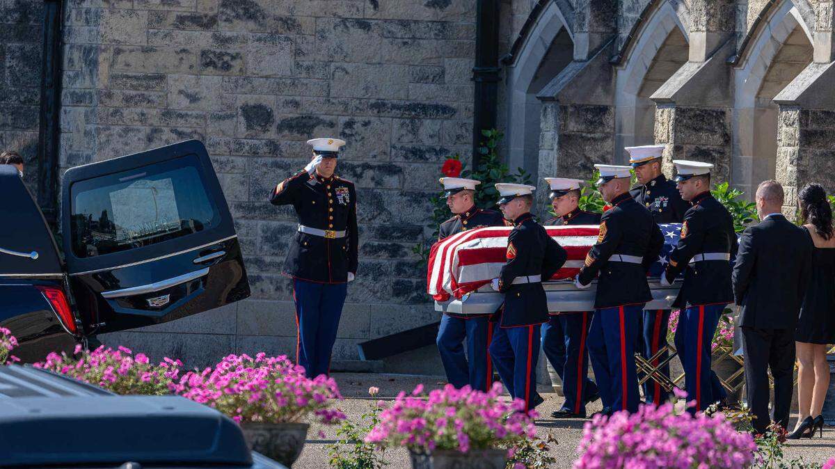 Marines carry the American flag-draped casket of Capt. Eleanor “Ellie” Cooke, formerly LeBeau, from Cathedral of St. Peter Catholic Church in Belleville to a hearse after her funeral service on Saturday.
