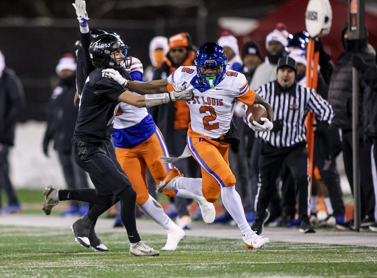 East St. Louis’ Ronnie Gomiller carries the ball against Fenwick during the IHSA Class 6A championship game.
