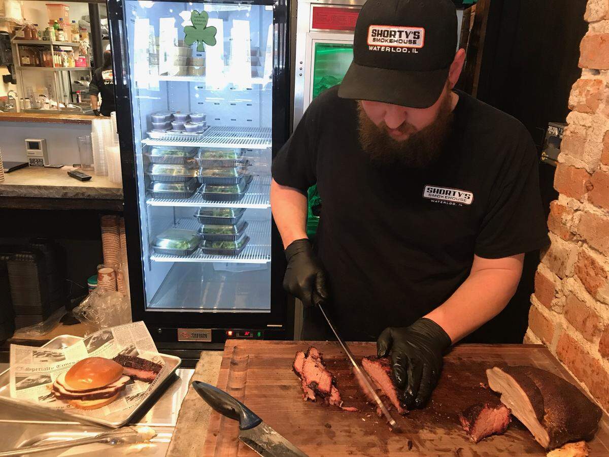 Co-owner and chef Anthony Hassler works behind the counter at Shorty’s Smokehouse in Waterloo.