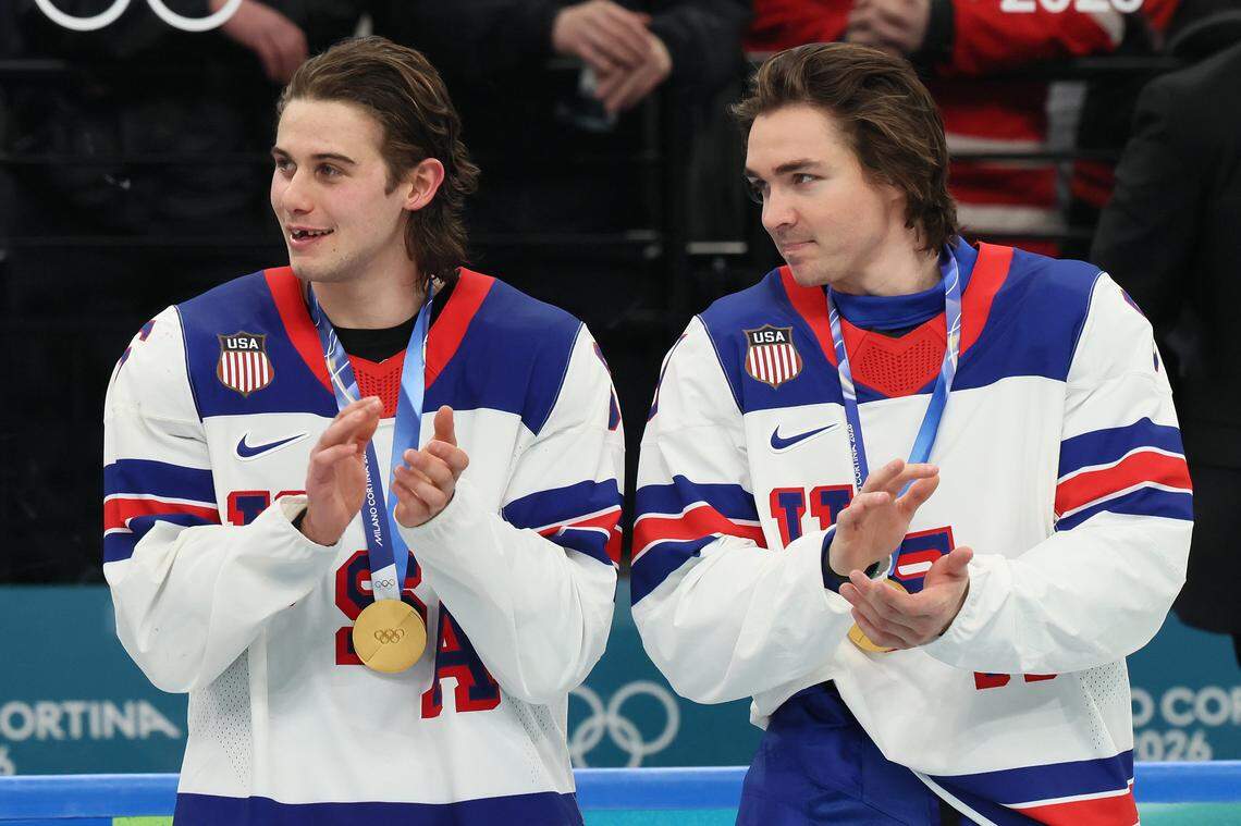 MILAN, ITALY - FEBRUARY 22: Gold medalist Jack Hughes #86 and Clayton Keller #91 of Team United States celebrate following the Men's Gold Medal match between Canada and the United States on day 16 of the Milano Cortina 2026 Winter Olympic games at Milano Santagiulia Ice Hockey Arena on February 22, 2026 in Milan, Italy. (Photo by Bruce Bennett/Getty Images)