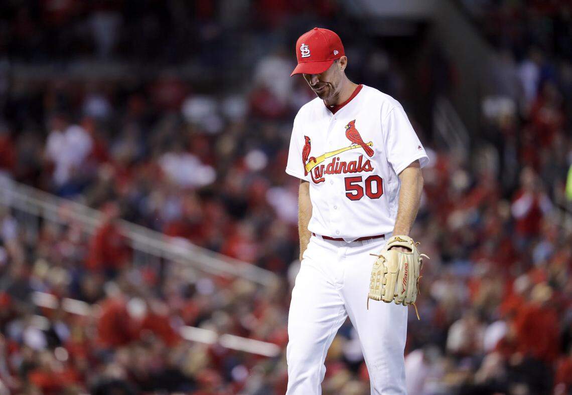 Adam Wainwright walks off the field after being removed during the fourth inning of Thursday's home opener against the Arizona Diamondbacks.