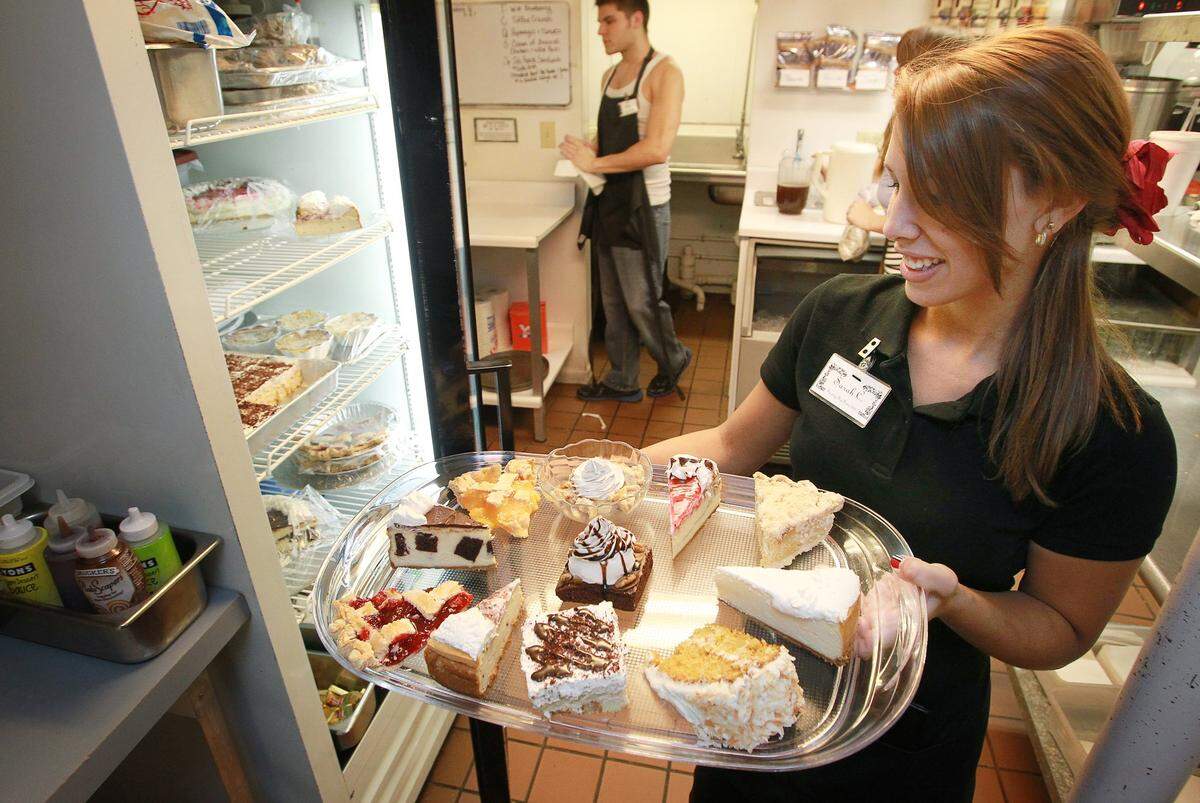 Waitress Sarah Cable puts away a dessert tray at Rachel's Garden in 2013.