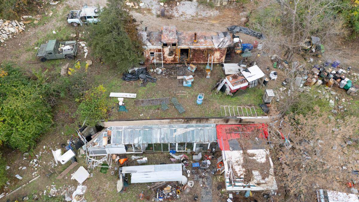 Drone photo showing the Euge property near Columbia, IL. In the foreground is Jason Euge’s underground house. His later father Robert, lived in the old caboose that sits on top, along the sodden roof.