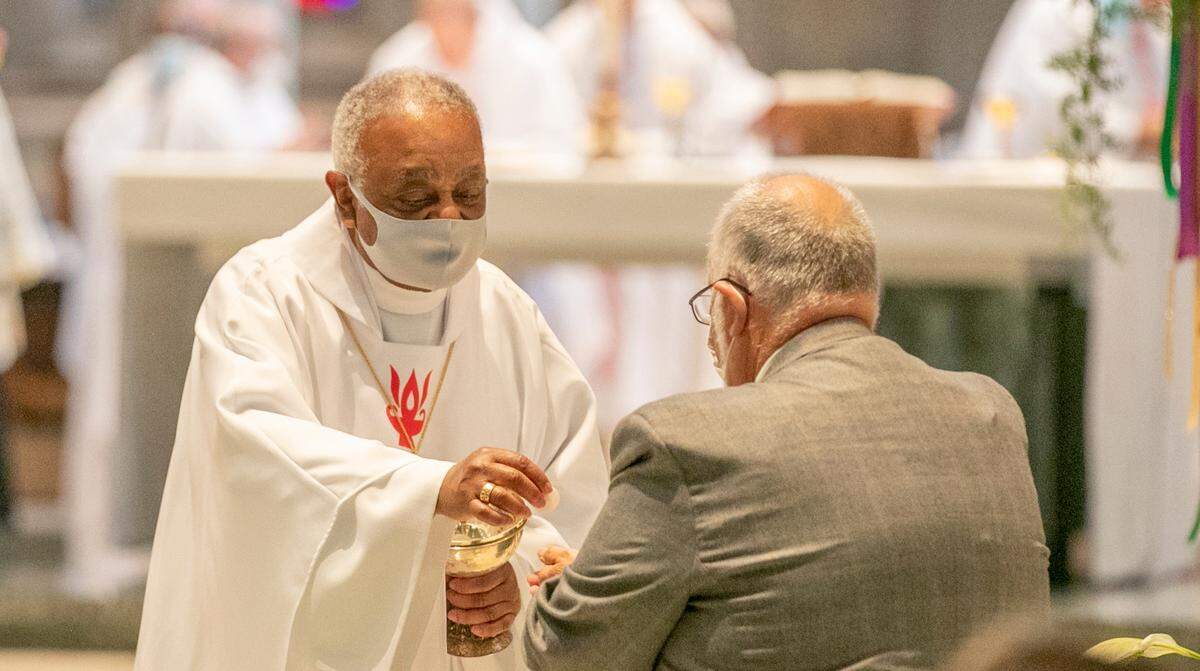 Archbishop Wilton D. Gregory, former bishop of the Catholic Diocese of Belleville, gives communion during a Mass of ordination and installation for new Bishop Michael G. McGovern on Wednesday at the Cathedral of St. Peter in Belleville.