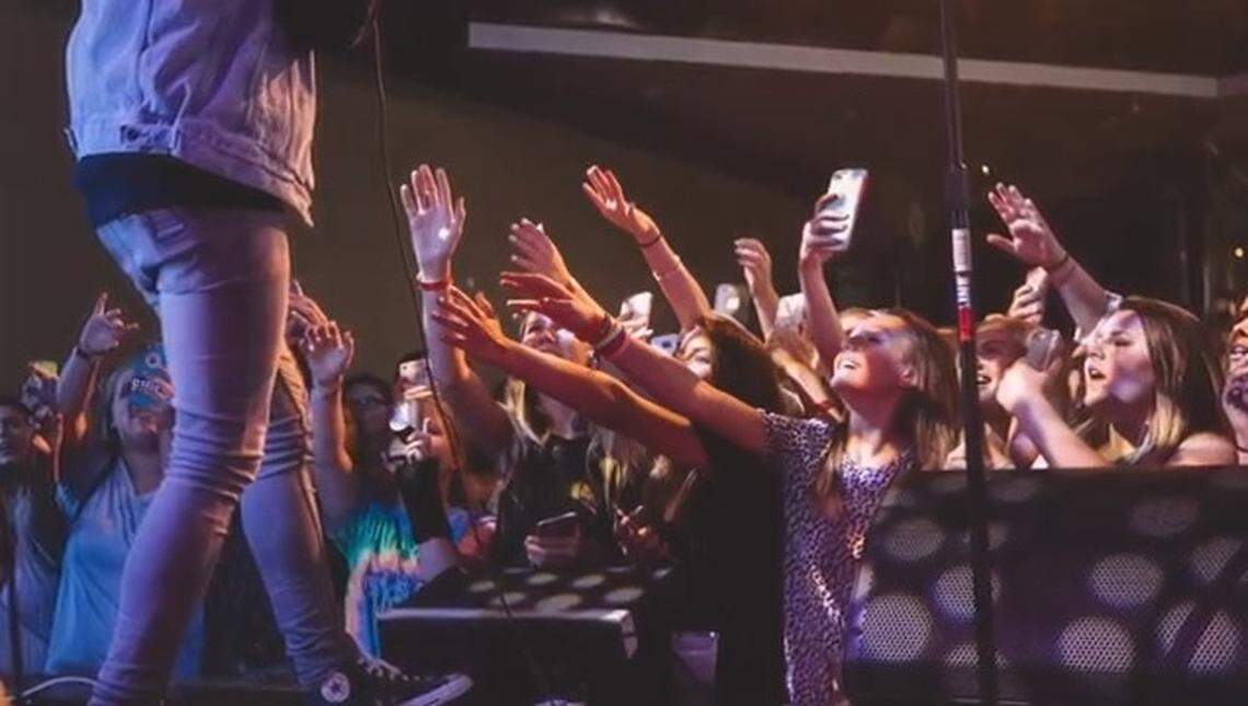 Adoring fans, mostly teenage girls, take photos and reach out for singer AJ Mitchell during a 2017 performance at the Old Rock House in downtown St. Louis.