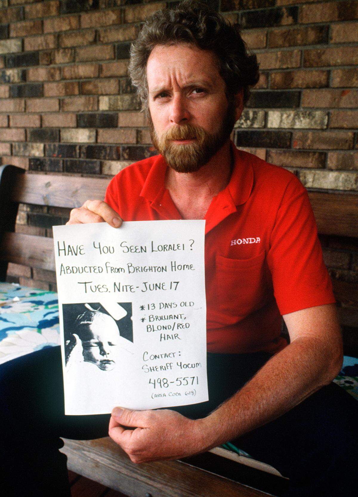 Robert Sims holds a missing person poster for his daughter, Loralei, in 1986. The baby was 13 days old when he and his wife, Paula Sims, reported her fake abduction.