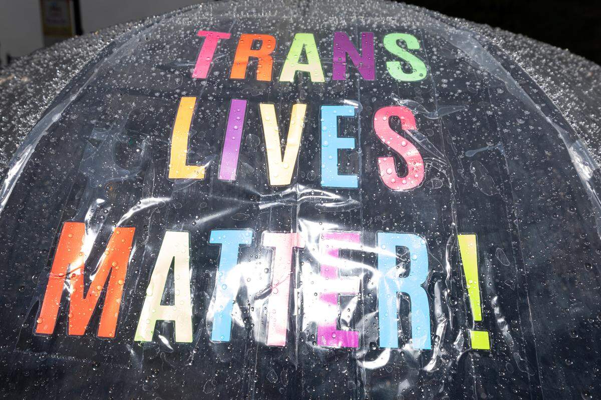 An umbrella displaying the words “Trans lives matter” during a rainy protest at Belleville’s Public Square Saturday.