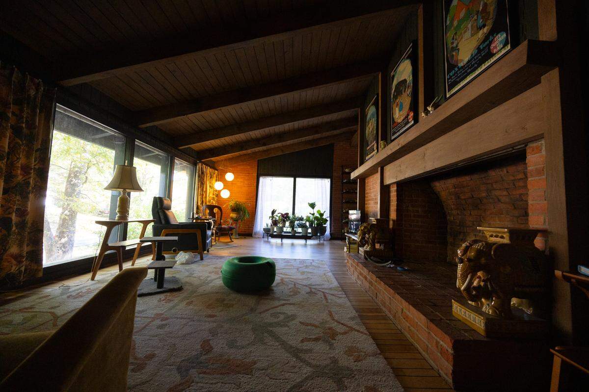 Inside a home on Knollwood Drive. The slanted roof and craftsman brick fireplace is a strong characteristic of this charming 1960s midcentury home.