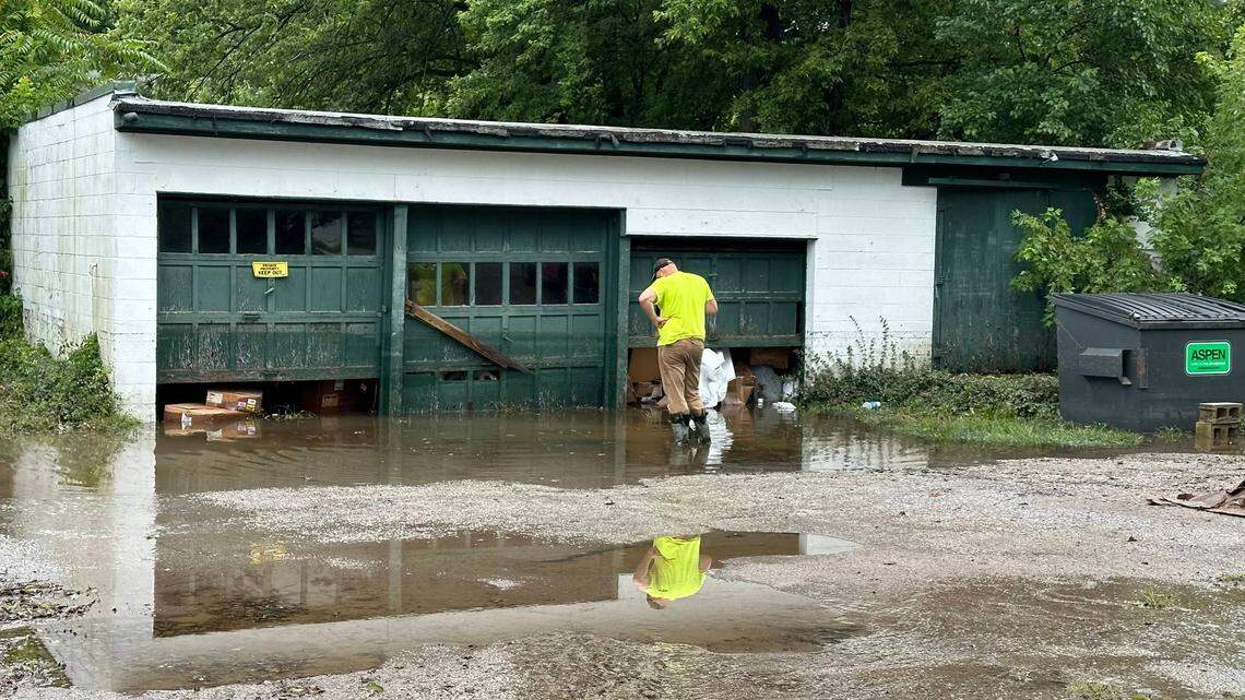 A City of Belleville worker shovels out blockage in a backlot sewer drain on July 16, 2024. According to Dorian LeRoy, owner of the property that flooded, this drain being blocked is what caused the major water buildup.
