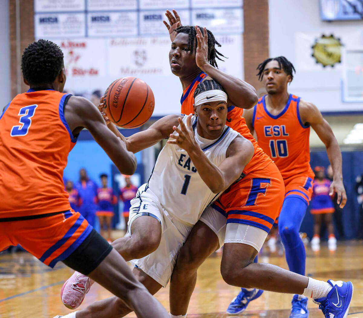 Belleville East’s Jordan Pickett drives to the basket against East St. Louis’ Macaleab Rich during Friday night’s Southwestern Conference game. The Flyers ultimately posted a 59-45 victory.