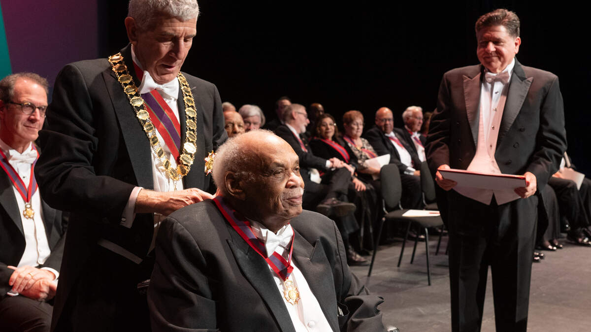 Reginald Petty receives the Order of Lincoln over the weekend at Southern Illinois University Edwardsville, as Illinois Gov. JB Pritzker watches.