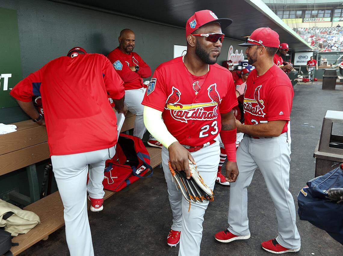 Marcell Ozuna shares a laugh with teammates before taking the field for a spring training game at Roger Dean Stadium.