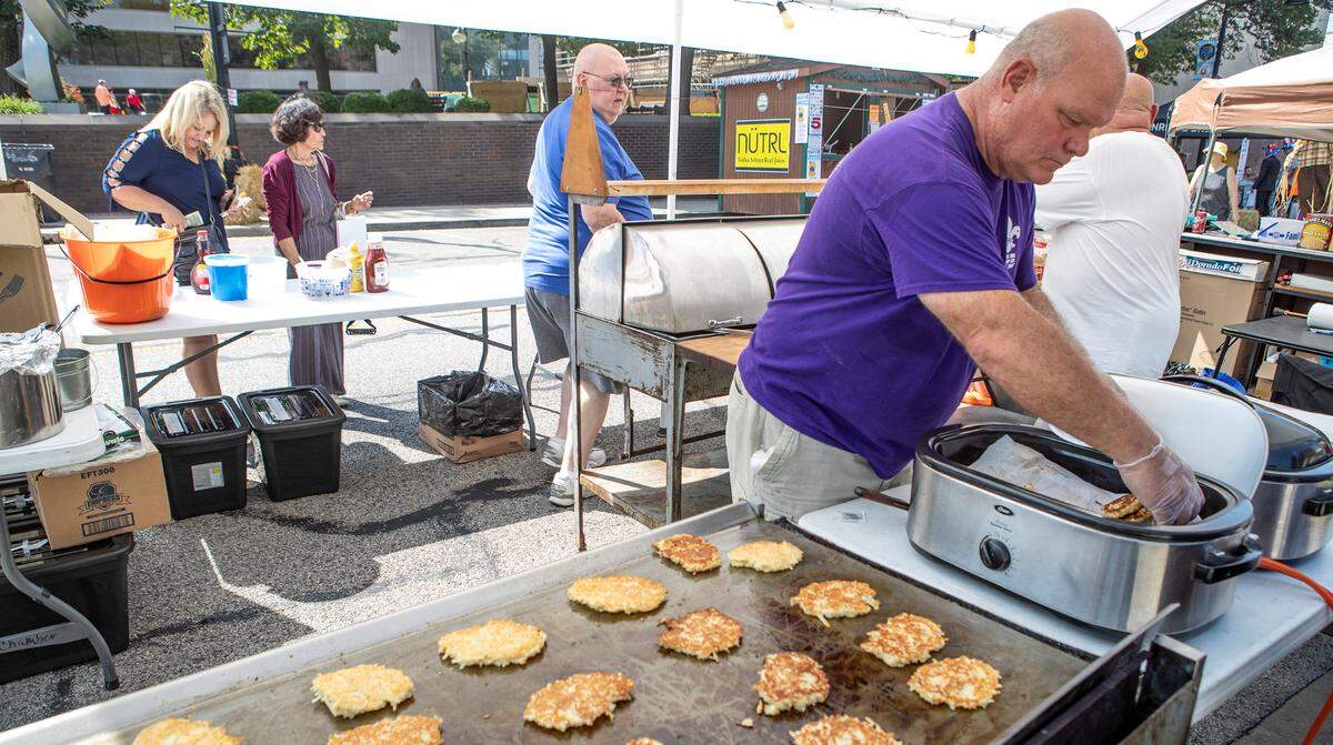 Boy Scout Troop 520 troop leader Mark Schmitz prepares potato pancakes for customers at Oktoberfest in Downtown Belleville. The Exchange Club and Troop 520 are serving potato pancakes, brats, sauerkraut and apple sauce during the 41st annual Belleville Oktoberfest that continues Saturday from 11 a.m. to 11 p.m. with food, live music, entertainment, games and beer.