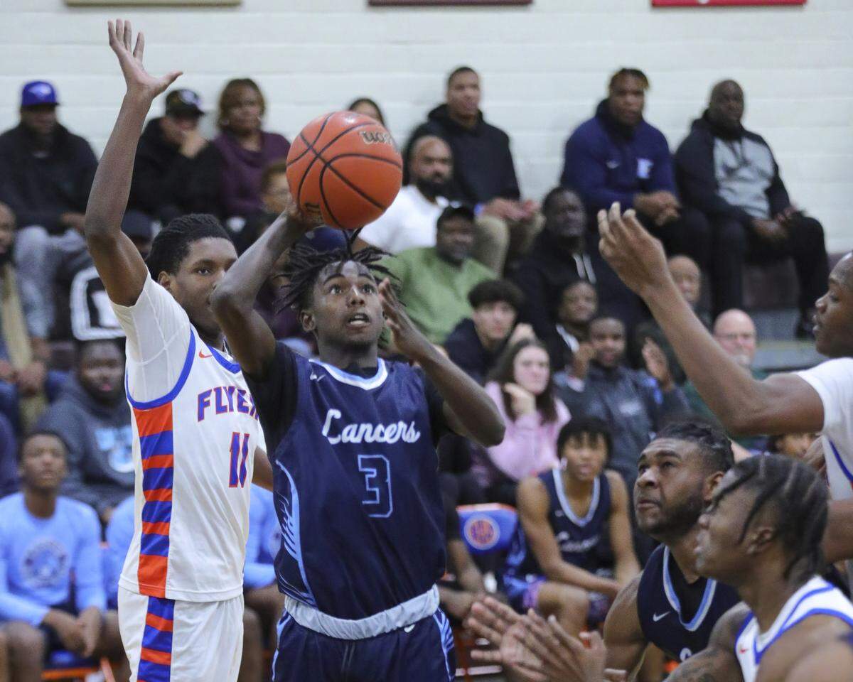 Belleville East’s Tallis Lowery takes a shot during Tuesday night’s Southwestern Conference game against East St. Louis. The Lancers ultimately dropped a 72-71 decision.