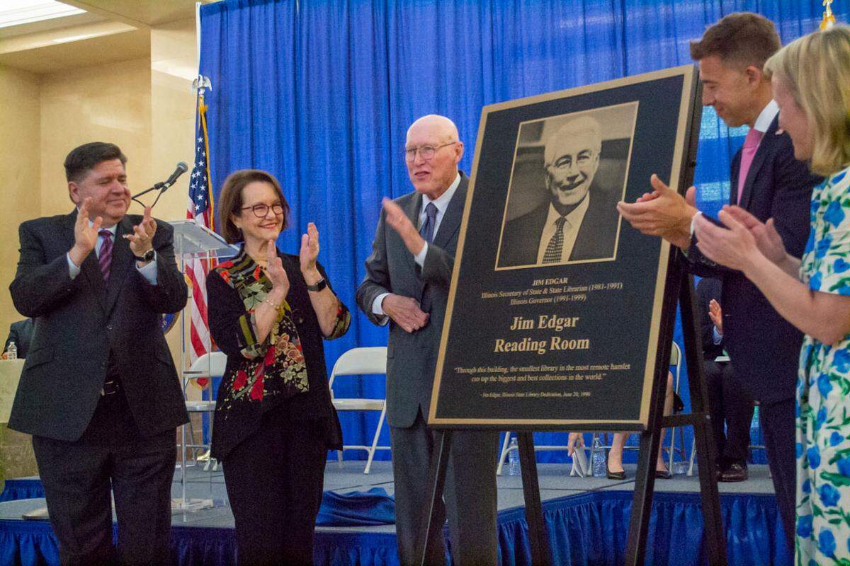 Former Republican Gov. Jim Edgar, center, unveils a plaque honoring his name on the reading room at the Illinois State Library. Also pictured are Gov. JB Pritzker, Edgar’s wife Brenda, Secretary of State Alexi Giannoulias and Congresswoman Nikki Budzinski.