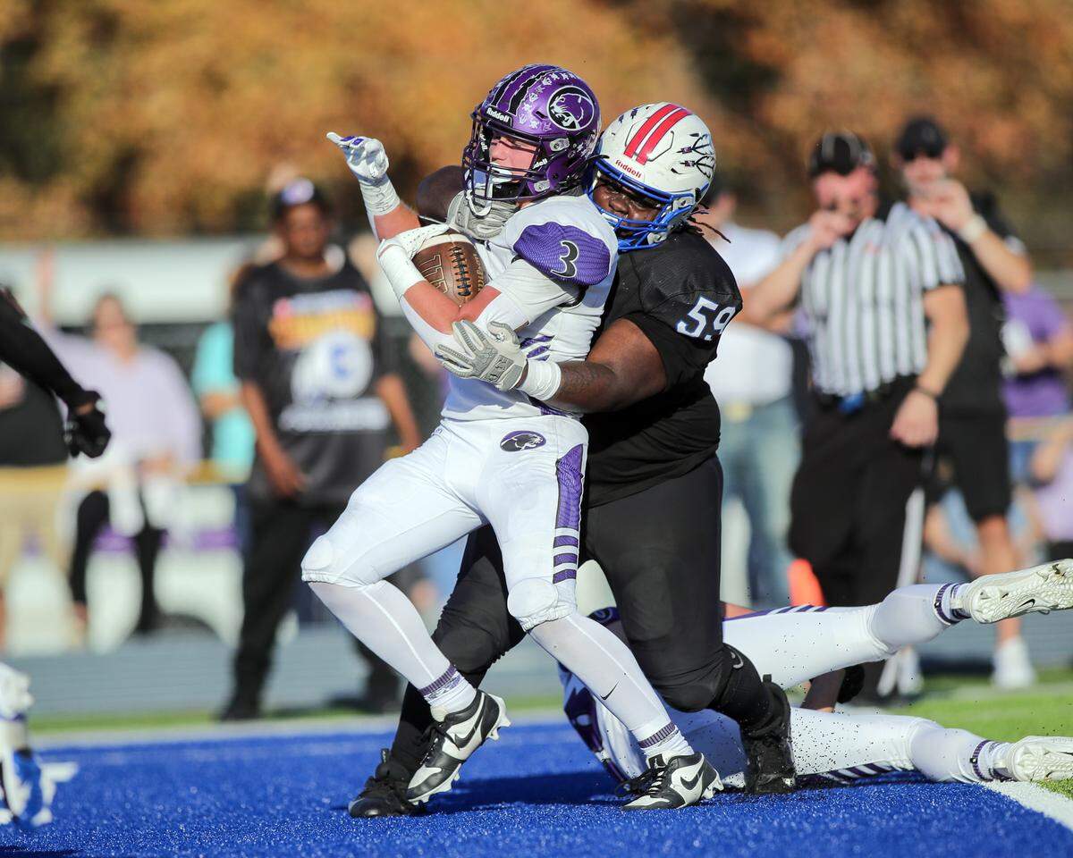 Central’s Conlan Harr scores the Cougars’ first of their quarterfinal playoff game win over Cahokia Saturday.