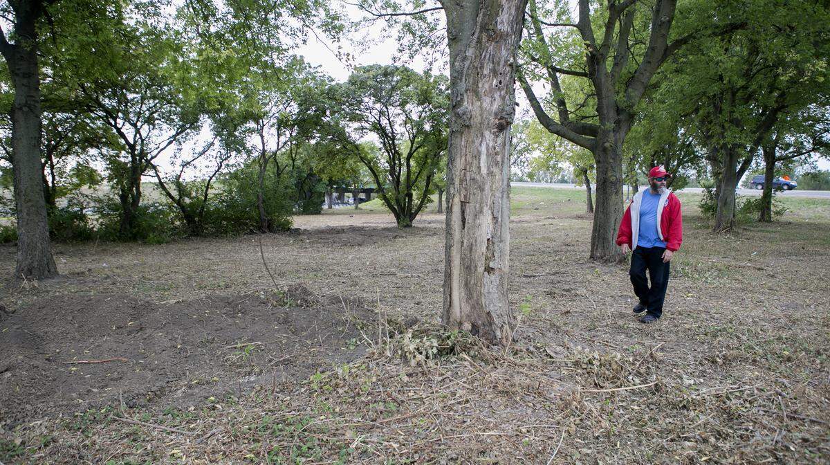 In this 2019 file photo, former Washington Park resident Scott Rose checks out property at the Interstate 64-Illinois 111 interchange that was part of a Black cemetery before it was moved in the 1960s.