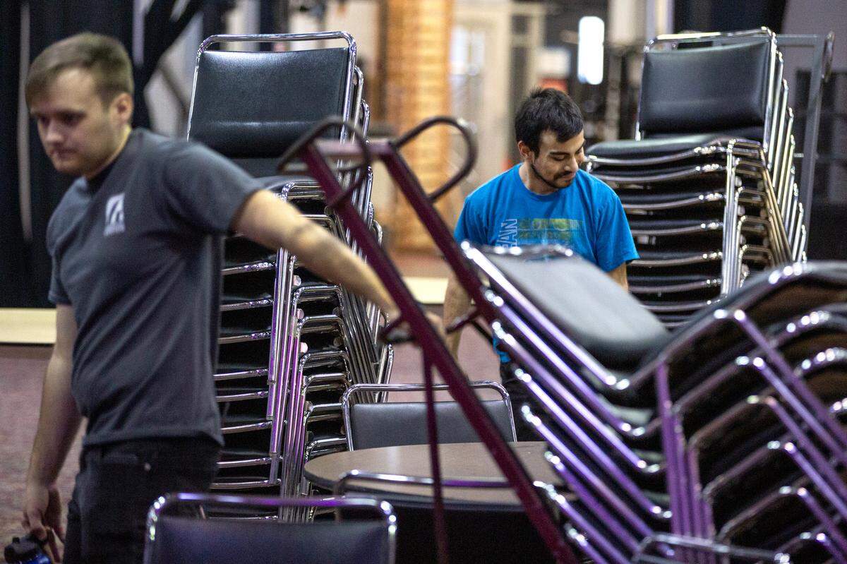 Alongside other members of the crew, Joseph Sanchez, 18, left, sets up chairs in preparation for an upcoming event on Tuesday, Nov. 14, 2023, at the Gateway Convention Center in Collinsville, Ill. Sanchez is a senior at Collinsville High School and a part of an apprenticeship program for students with disabilities.