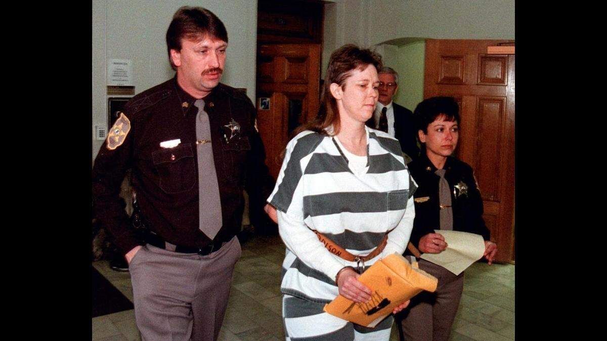In this 1999 file photo, Madison County sheriff’s deputies lead Paula Sims away from a Madison County courtroom in shackles after a hearing in Edwardsville.