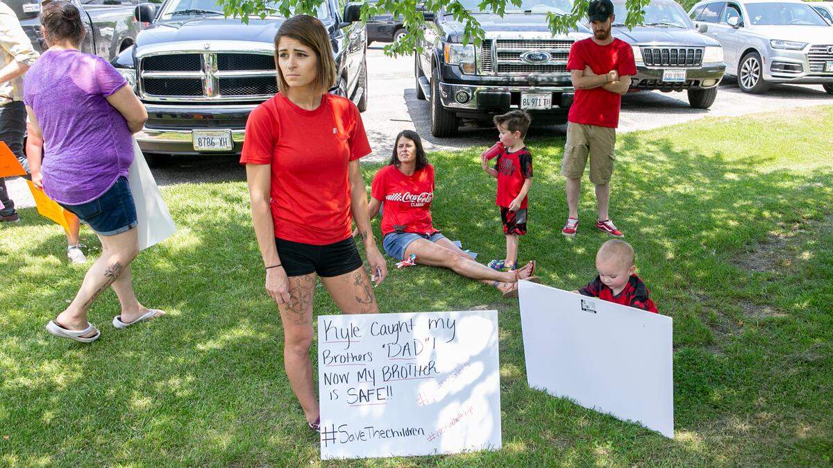 Destiny Silkwood, of Mascoutah, waits with family members for a protest supporting Kyle Swanson, founding leader of KTS Predator Hunters, on Friday at Spencer T. Olin Community Golf Course in Alton, where Madison County State’s Attorney Tom Haine was holding a fundraiser. The protest didn’t happen.