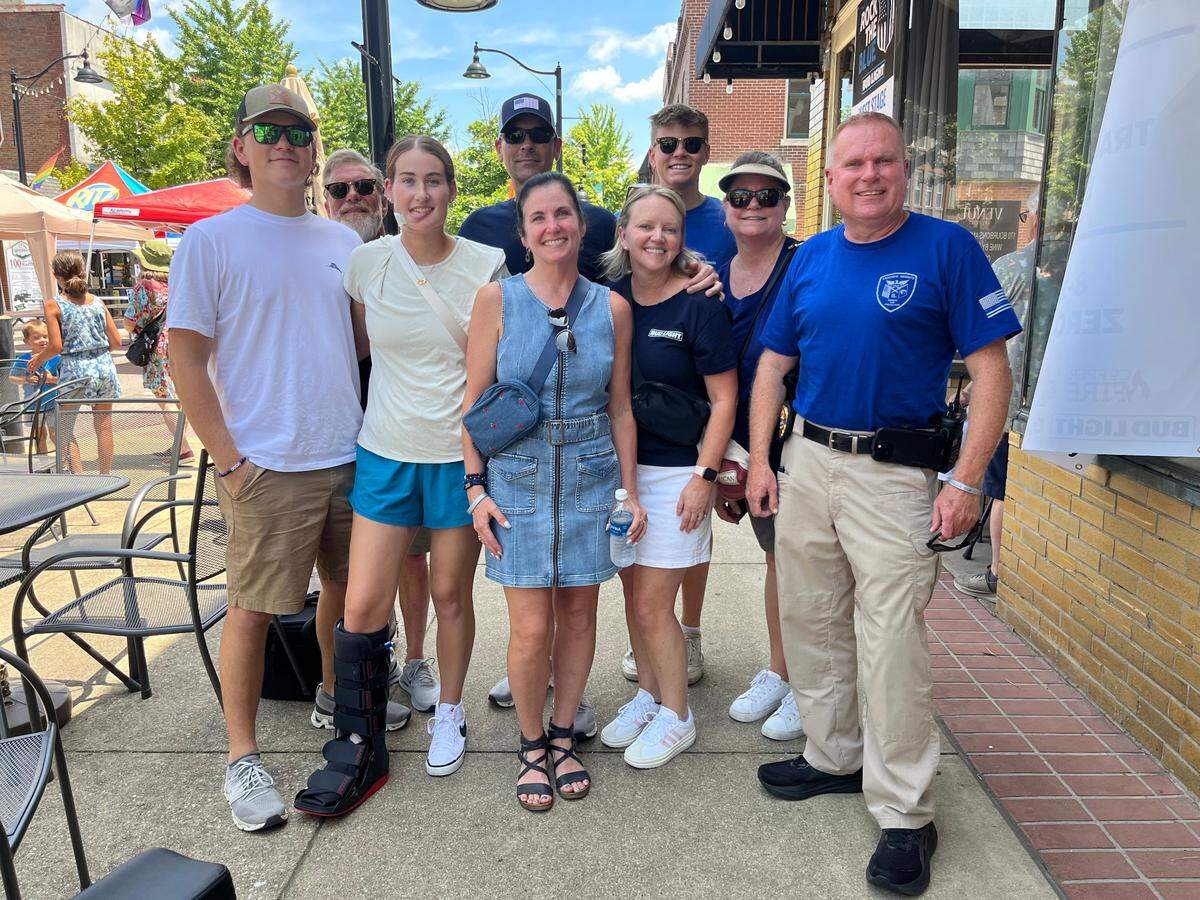 Injured Fairview Heights police officer Molly Muennich, third from left, poses with family and friends at a Rock the Blue fundraiser on Saturday in downtown Belleville. Also pictured are fiance Devon Rathbun, left, father and stepmother Larry and Julie Muennich, fourth and sixth from left, mother Brigette Brouillard, fifth from left, and Police Chief Steve Johnson, right.