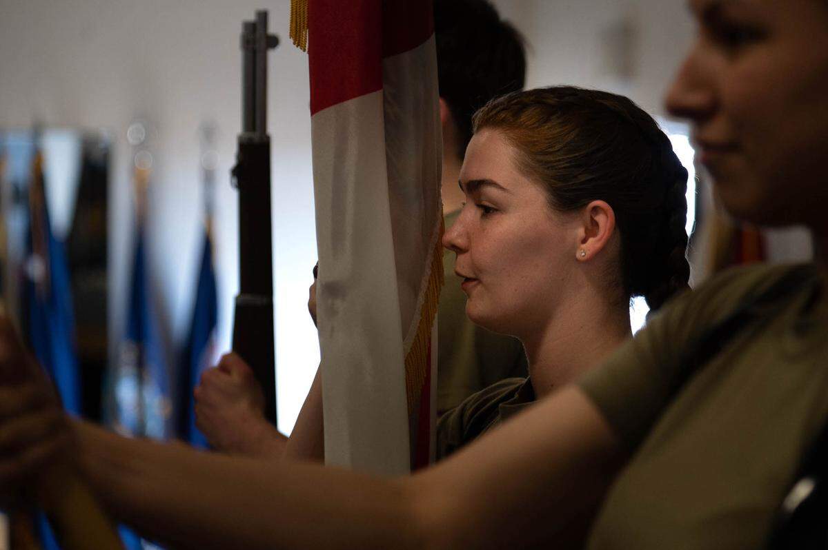 U.S. Air Force Senior Airman Miranda Underwood, 375th Medical Group pharmacy technician, trains during a colors detail practice on Scott Air Force Base. Guardsmen hold the flags at present arms during the playing of the national anthem.