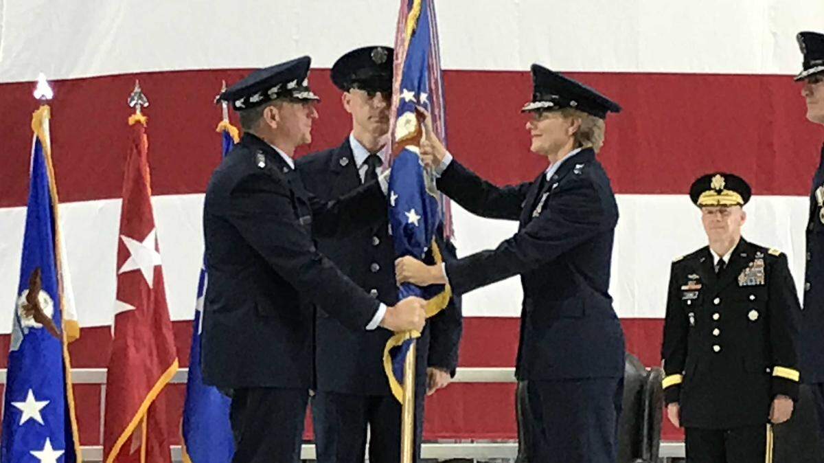 Gen. David Goldfein, Air Force Chief of Staff, passed the Air Mobility Command guidon to Gen. Maryanne Miller during a change-of-command ceremony Friday at Scott Air Force Base. Miller assumes command of AMC from Gen. Carlton D. Everhart II.