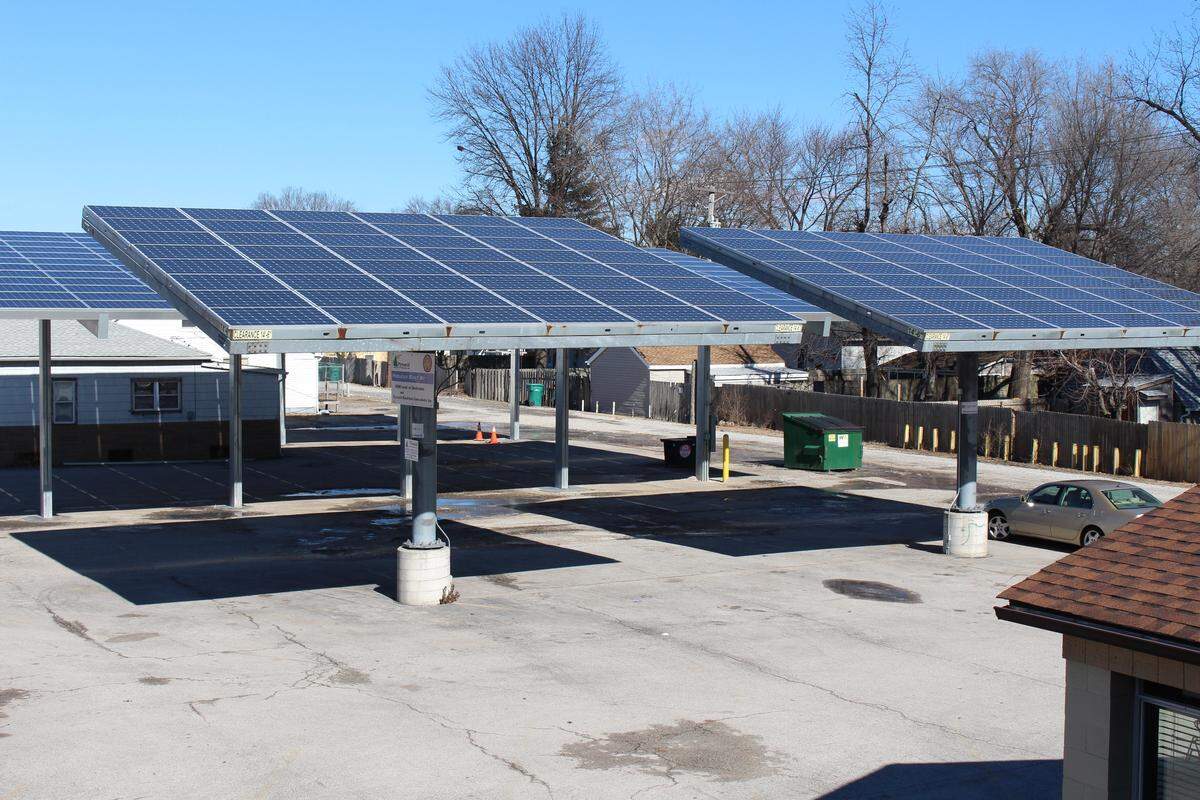 Pole-mounted canopies with solar panels generate electricity, but also provide covered parking for customers at Eddie’s Lounge in Granite City.