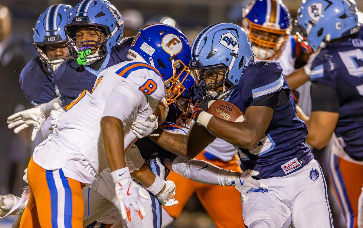 Belleville East’s Josh Ware carries against East St. Louis.