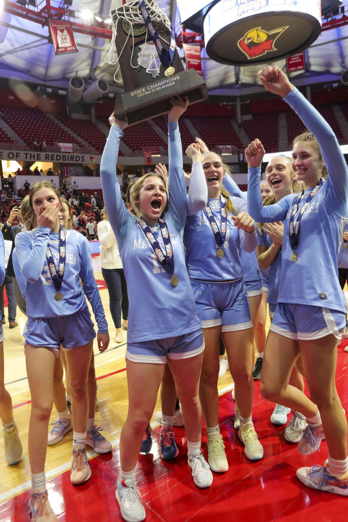 Mater Dei’s Carissa Litteken raises the championship trophy after defeating Byron in Saturday’s IHSA Class 2A state championship game at CEFCU Arena (formerly Redbird Arena) on the campus of Illinois State University.