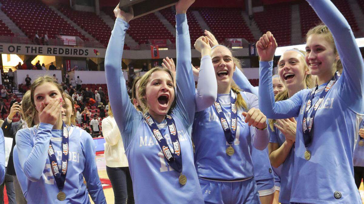Mater Dei’s Carissa Litteken raises the championship trophy after defeating Byron in Saturday’s IHSA Class 2A state championship game at CEFCU Arena (formerly Redbird Arena) on the campus of Illinois State University.