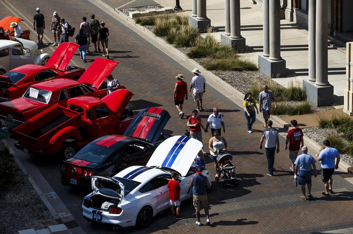 Visitors make their way down Capitol Avenue taking in the cars on display during 15th annual International Route 66 Mother Road Festival & Car Show on Sept. 24, 2016, in Springfield.