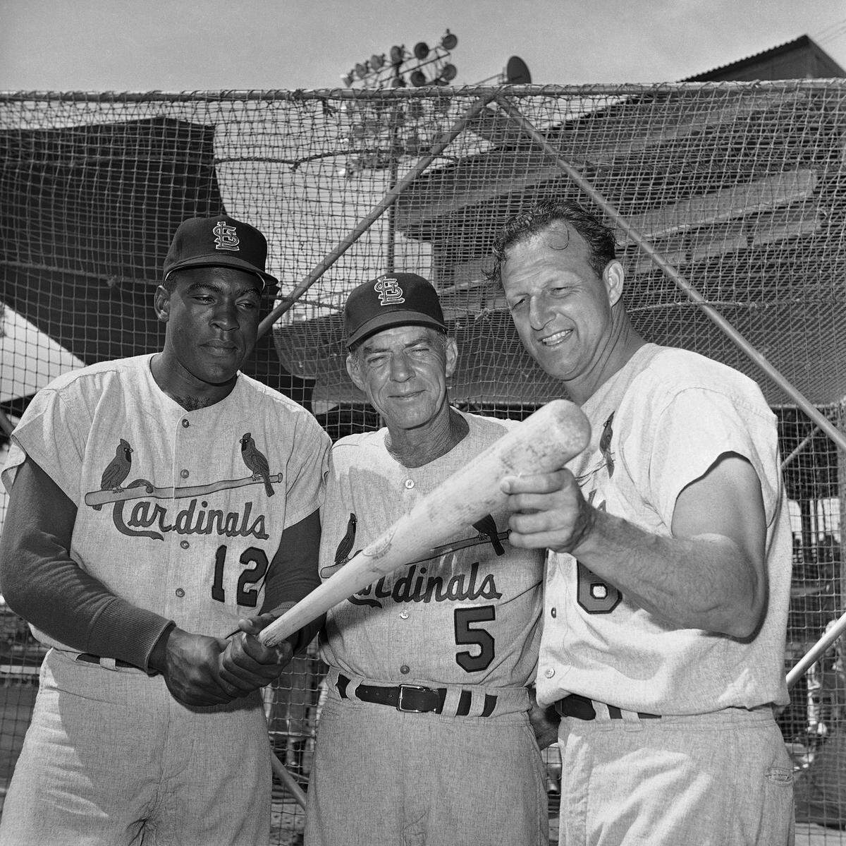 From left are Bill White; manager John Keane and Stan Musial of the St. Louis Cardinals on March 13, 1964 in St. Petersburg, Florida. (AP Photo/Harry Harris)