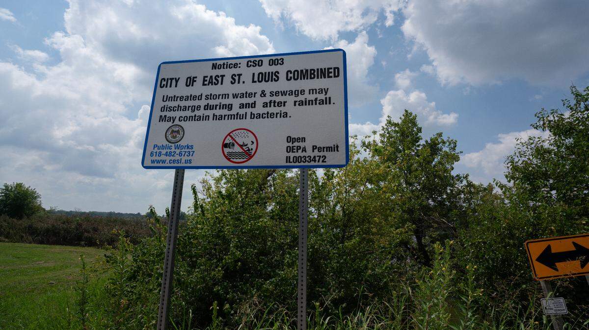 A sign at Frank Holten State Park in East St. Louis, where residents go for fishing and boating, warns about the possibility of untreated sewage spilling into the lake.