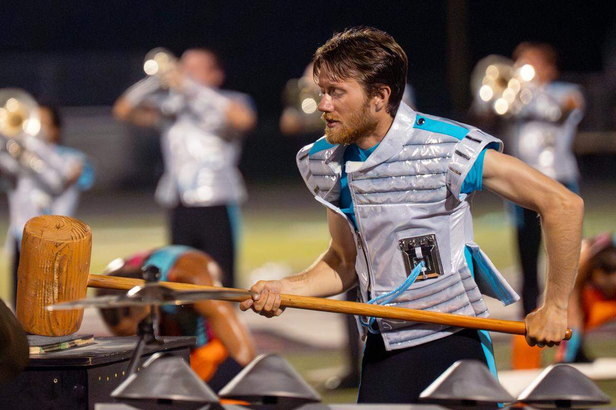 A Boston Crusaders percussionists plays the Mahler hammer during their show “BOOM” at Belleville West High School on Tuesday, July 22, 2025, in Belleville.