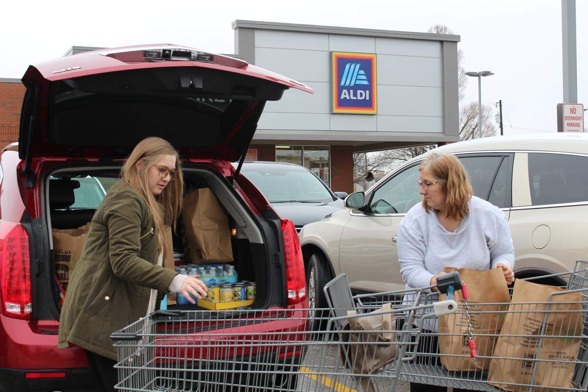 Kelsey Seim, left, and her mother, Kathy Seim, load their vehicle with groceries outside the Collinsville Aldi store on Wednesday afternoon. They found everything they needed.