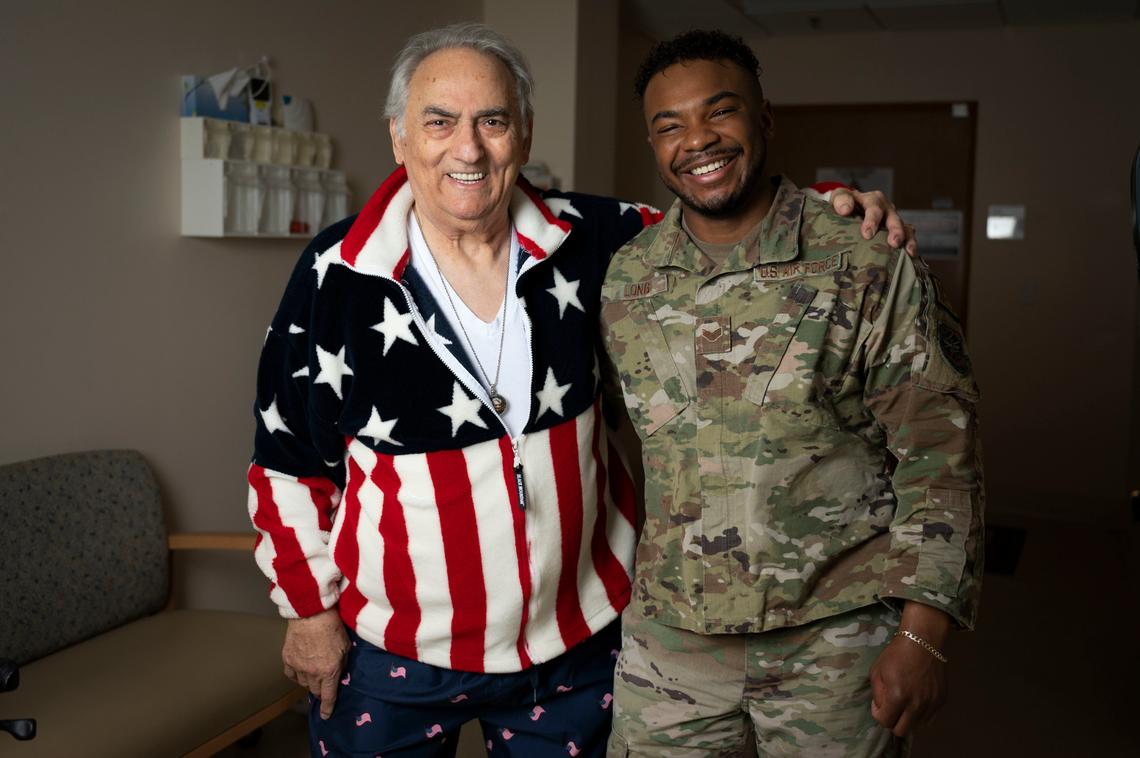 From left, retired Chief Master Sgt. Fernando Calvarese and Senior Airman Sharrdan Long, 375th Medical Support Squadron MRI technologist, share a moment together on Scott Air Force Base. Both grew up in the same orphanage — Milton Hershey School — which was founded by Milton Hershey in 1909 for underprivileged youth.