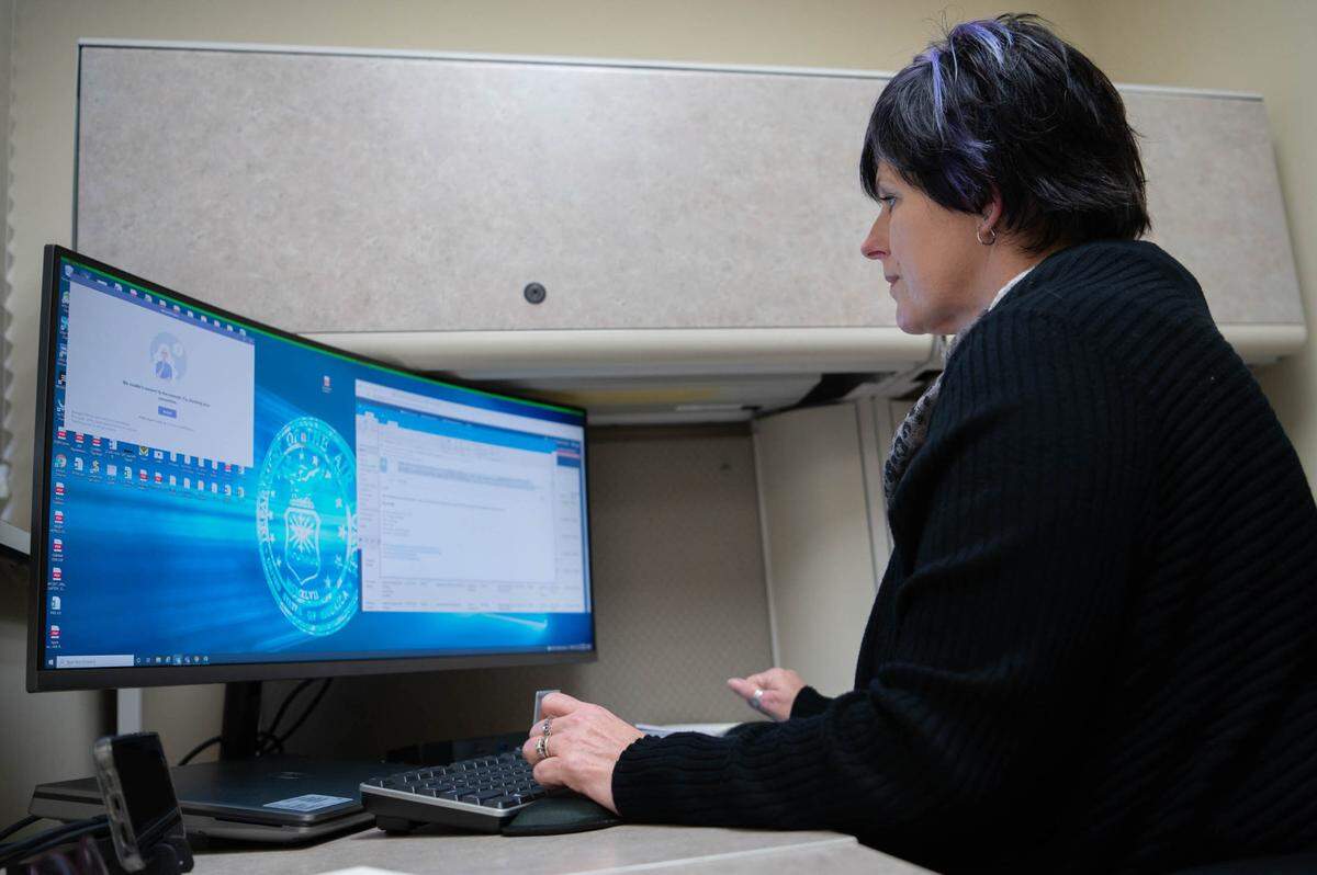 Tina Gowdy, 375th Contracting Squadron Government Purchase Card agency organization program coordinator team lead, works at her desk on Scott Air Force Base. The GPC team provides support for every member of Team Scott, as well as Geographically Separated Units such as Bahrain, Virginia and Germany.