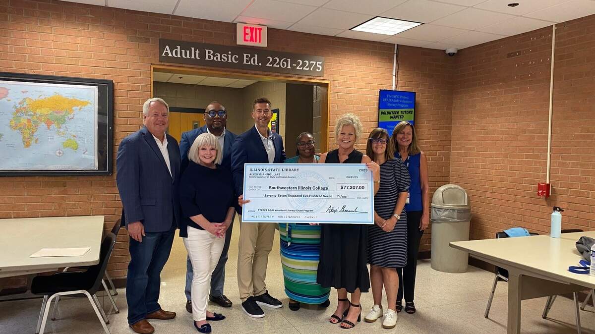 Illinois Secretary of State and State Librarian Alexi Giannoulias provides a ceremonial check of $77,207 to Southwestern Illinois College for its adult volunteer literacy program.