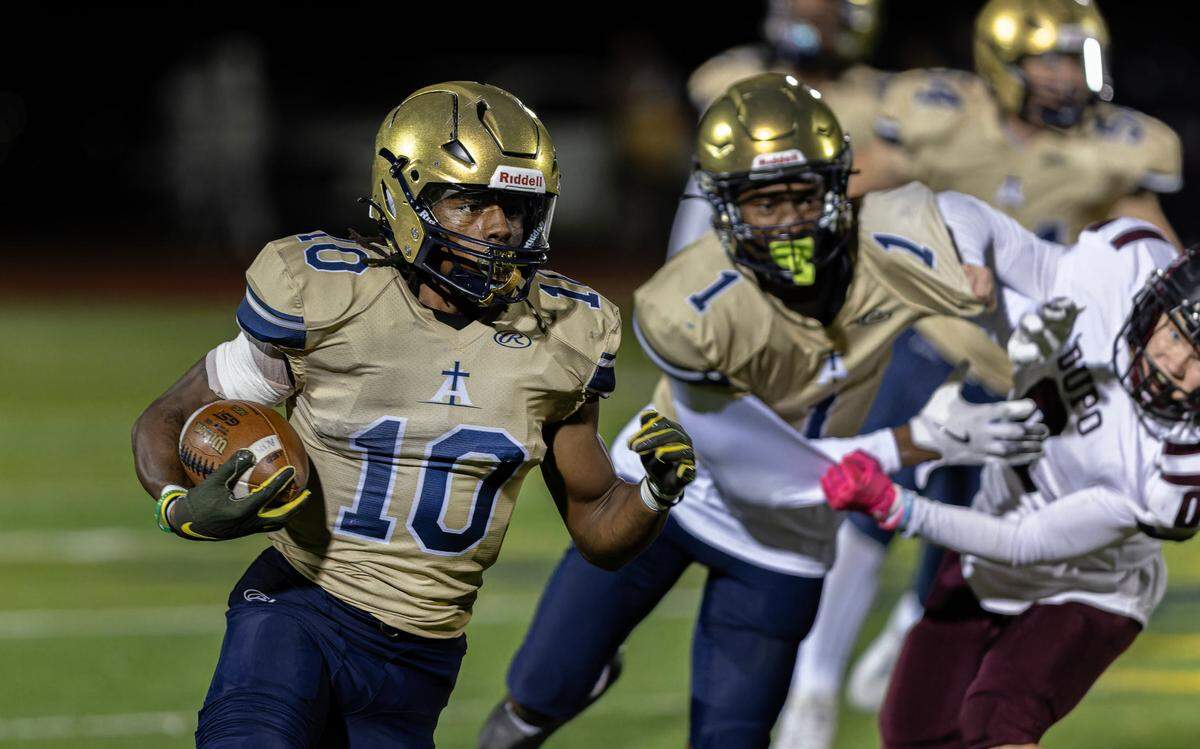 Althoff’s Dierre Hill Jr. (10) returned to limited action for the Crusaders’ first-round playoff game with Dupo after taking off the regular-season finale last week to nurse a shoulder injury. He made the most of three carries by amassing 123 yards rushing and two touchdowns.