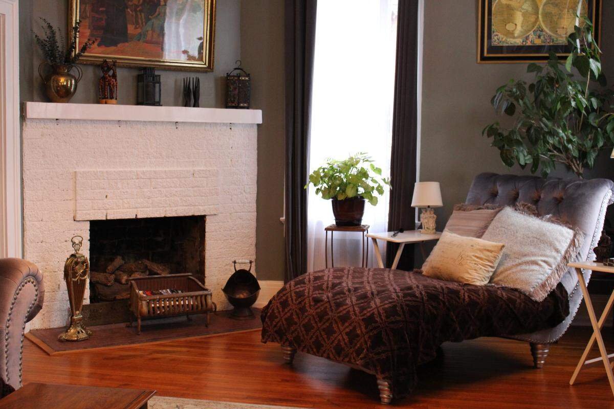 The living room in the McCullough family’s 1874 brick home on Abend Street in Old Belleville Historic District has a high ceiling, tall windows and a corner fireplace.