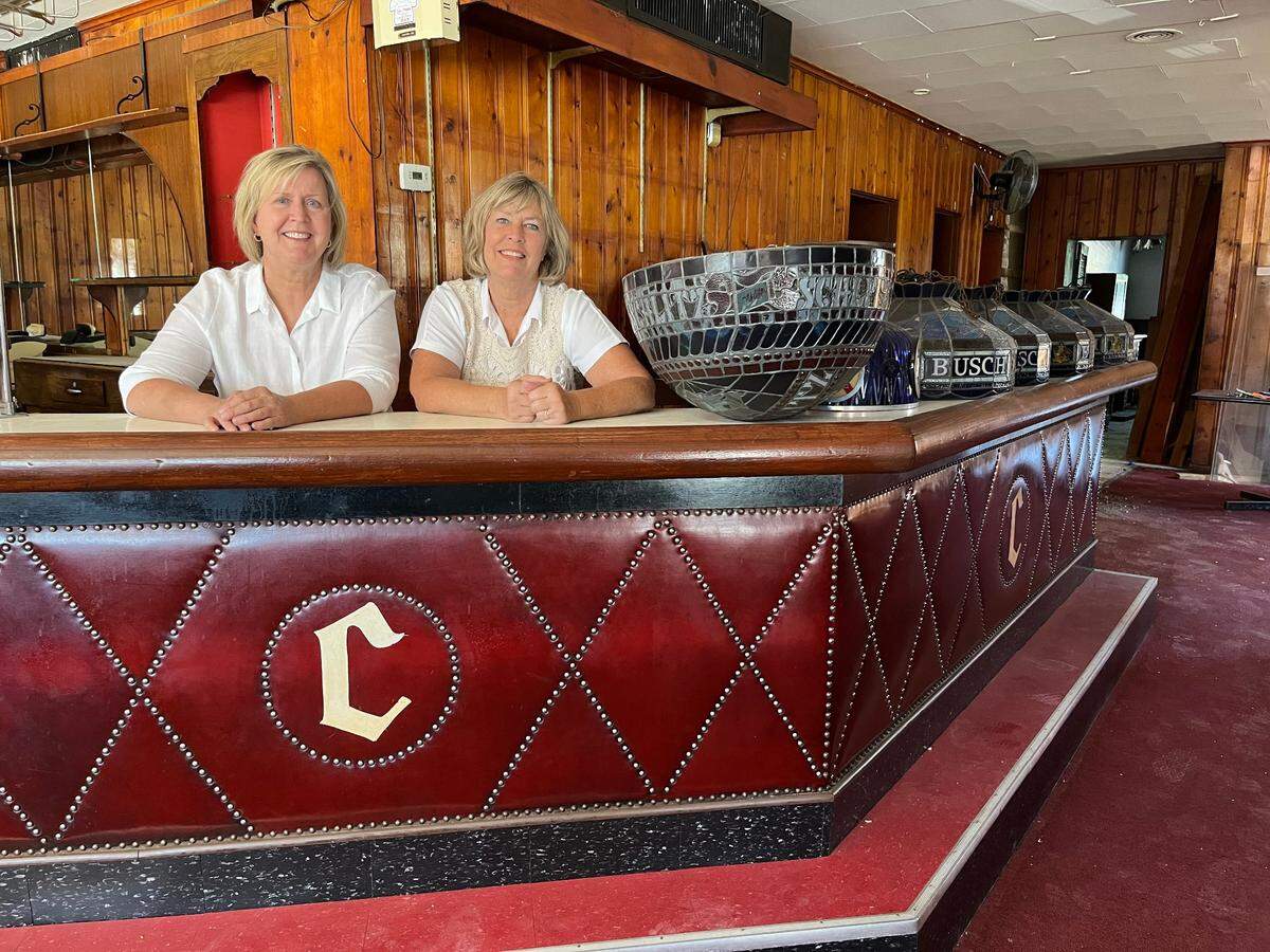 In this 2023 photo, sisters Barb Swantner, left, and Beth Rund stand behind the bar at Charlie’s Off Main, a restaurant and bar they renovated and reopened on Mascoutah Avenue in Belleville in August 2024.