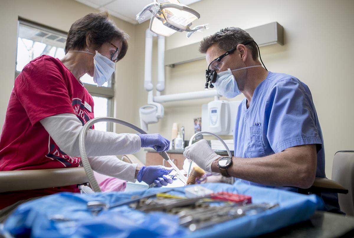 Clinical assistant Jen Blockley and Dentist Dr. Eric von Hoven work on a young patient during the Give Kids a Smile program at Cedar Creek Dental in Highland. Cedar Creek Dental, The Smile Shoppe and Plaza Dental Care in Highland all participated in the event that gave free dental treatments to students.