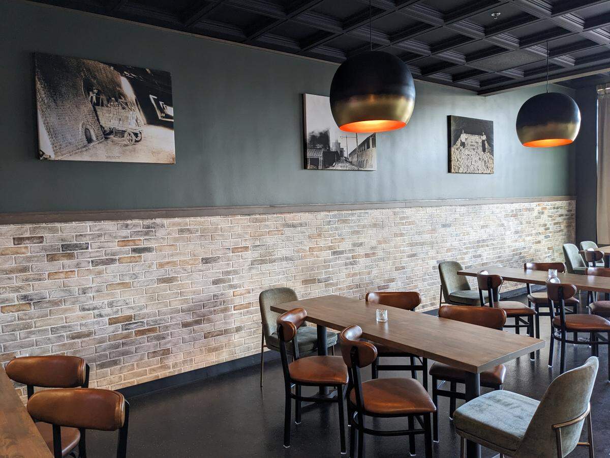 This 2023 photo shows part of the dining area at Brick + Bramble in Edwardsville, which features historic photos from the Richards Brick Company.